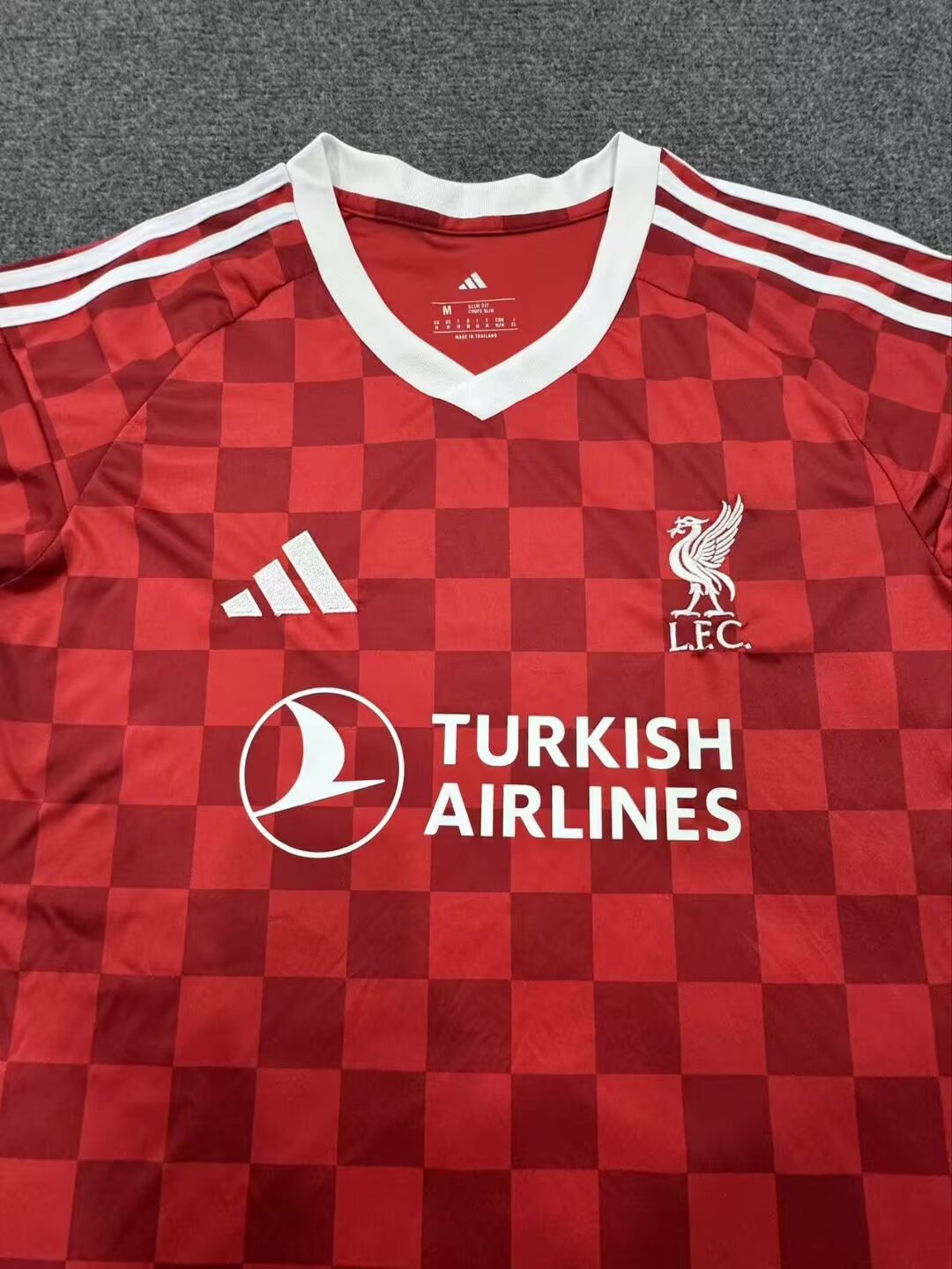 27/28 Liverpool home fan jersey crest and collar detail